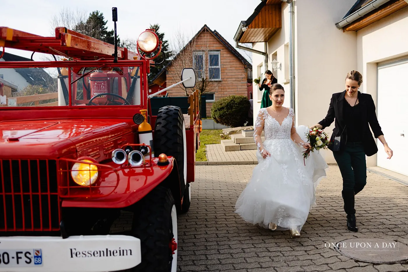 Amandine carrying the bride's train on the wedding day