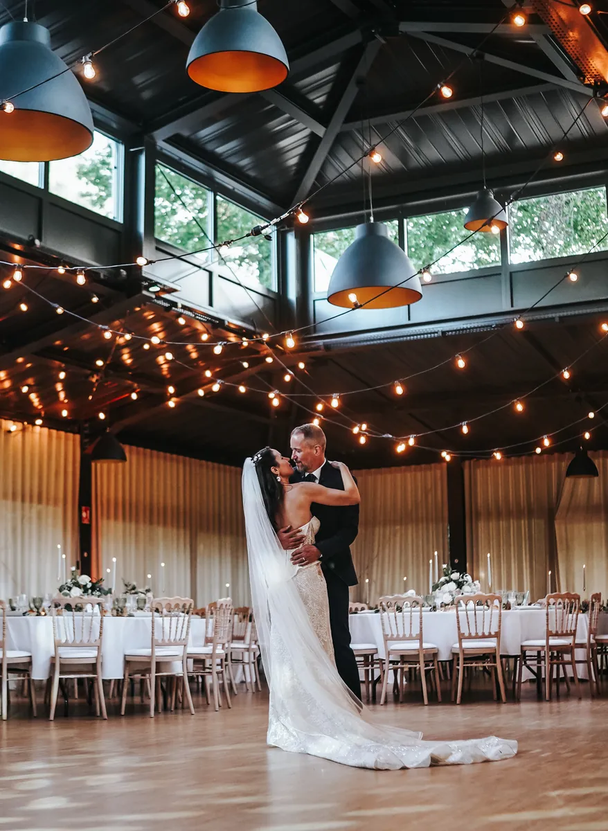 Couple in the reception hall of Villa des Hêtres Pourpres under string lights