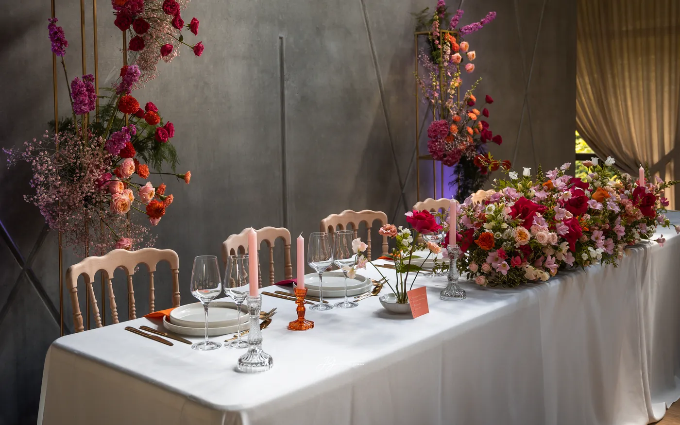 Reception table scenography with a floral arch and candles
